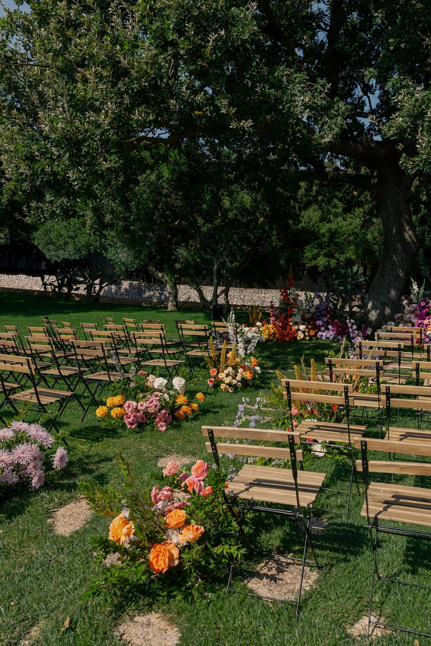 spontaneous growths with colorful flowers for wedding aisle at Masseria Grieco in Italy