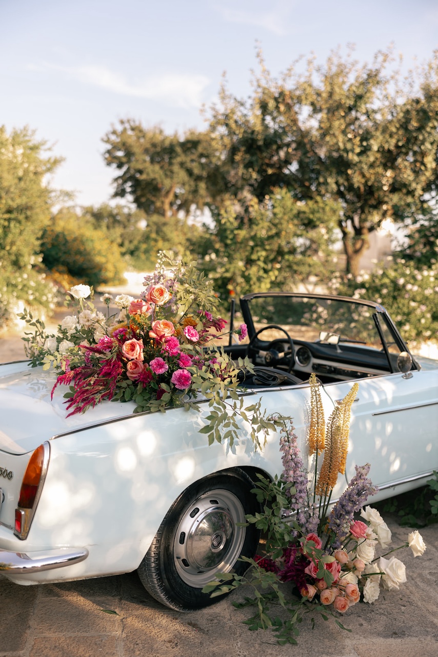 wedding car with spontaneous growths and colorful flowers