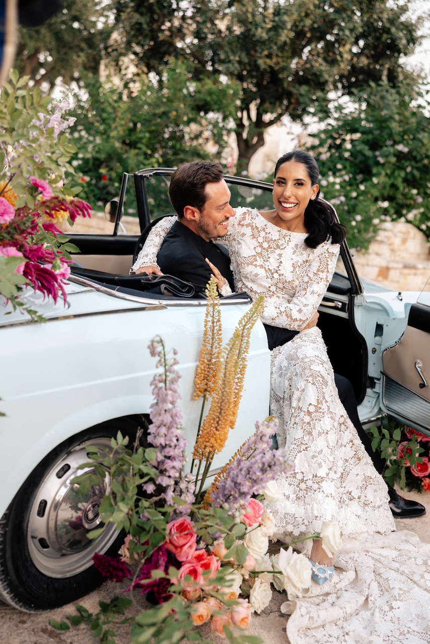 wedding car with natural growths full of flowers at Masseria Grieco