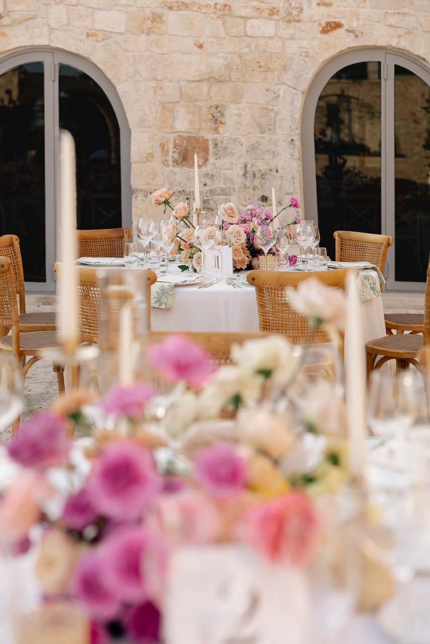 table layout for Hindu wedding in Italy with corlorful centerpieces