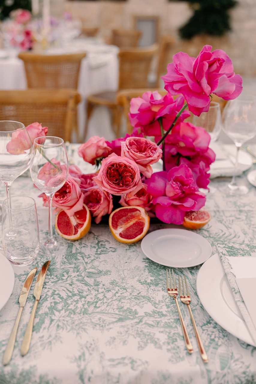 hot pink roses with red oranges centerpiece for indian wedding at Masseria Grieco