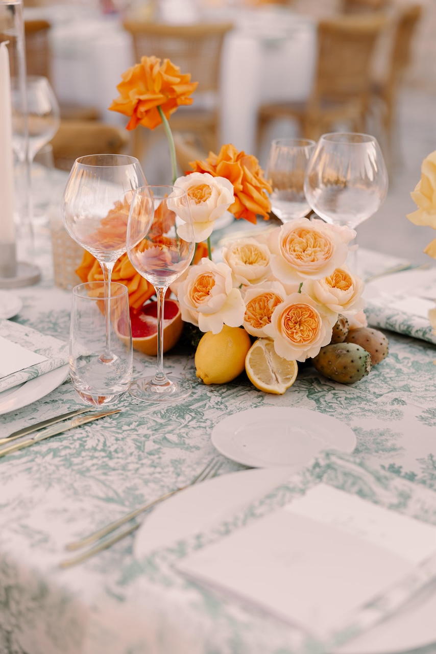 centerpiece with light orange english roses with lemons and grapefruit for italian wedding