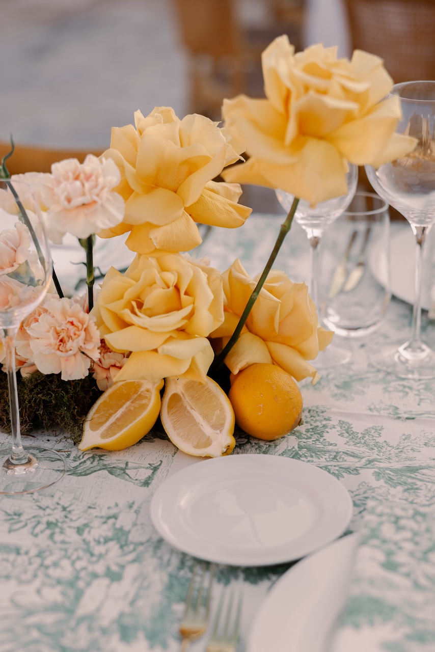 yellow roses and fresh lemons centerpiece for indian wedding