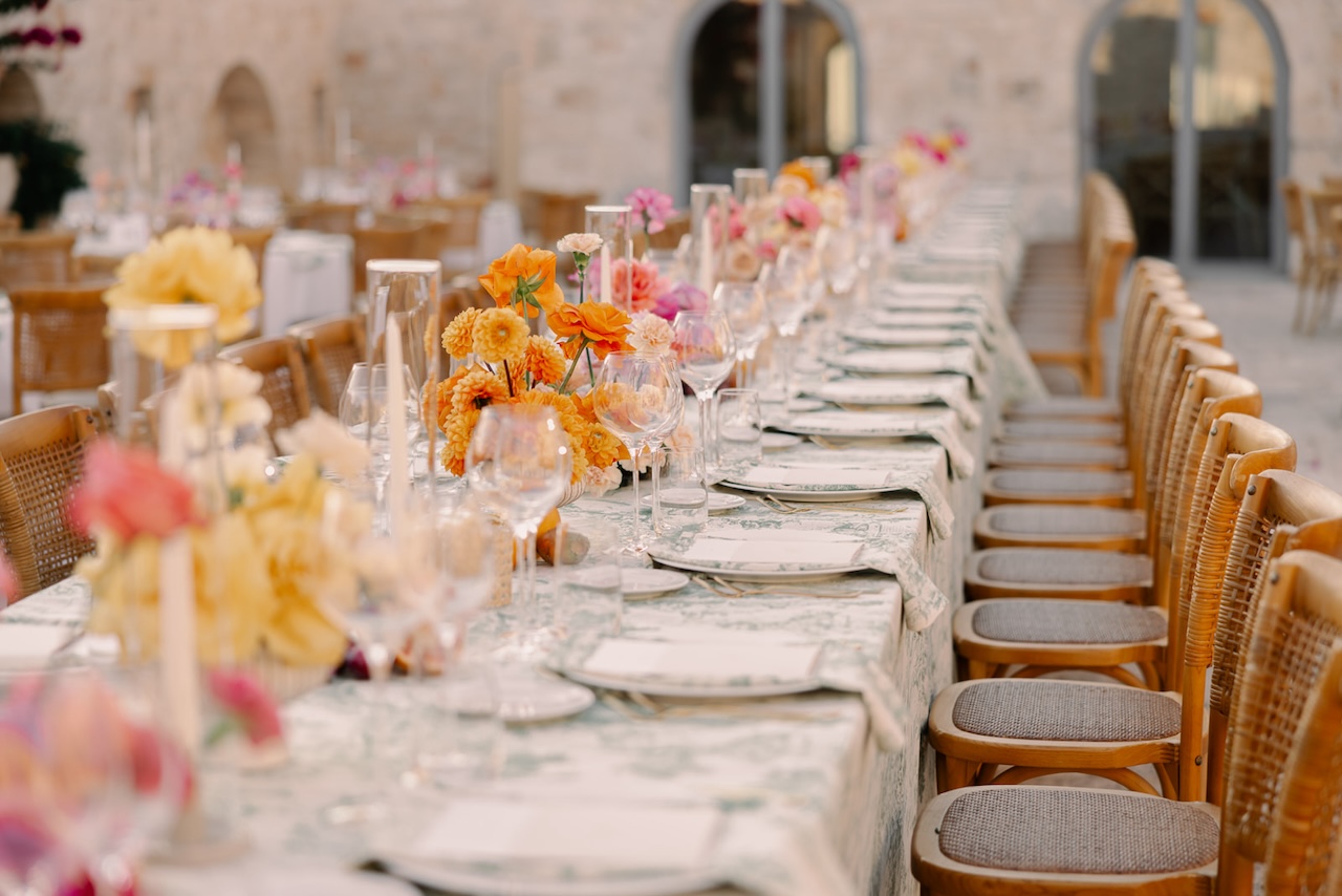 orange and pink flowers for centerpieces and green toile de jouy tablecloth for indian wedding