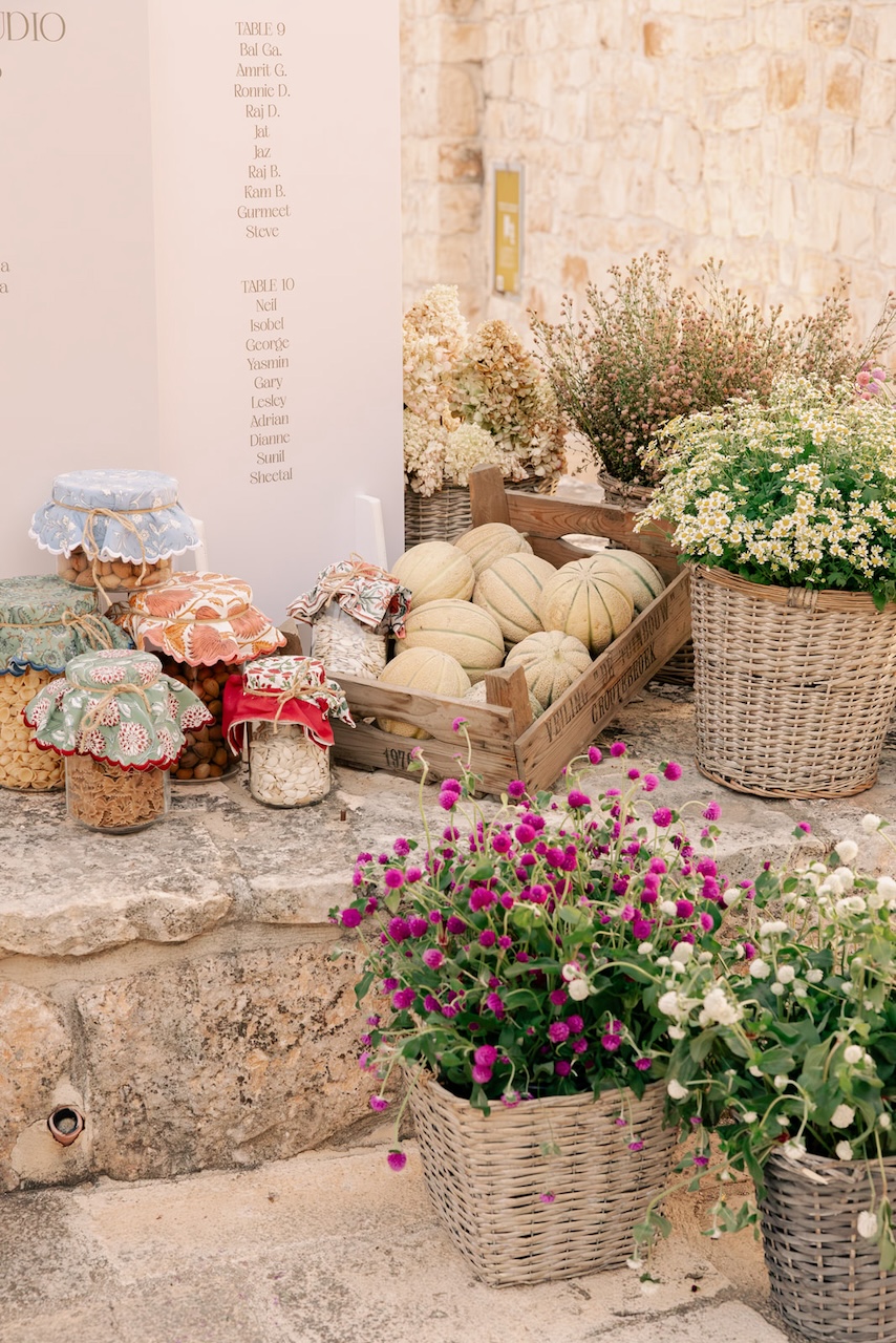 table layout with wicker baskets full of colorful flowers and fresh fruits