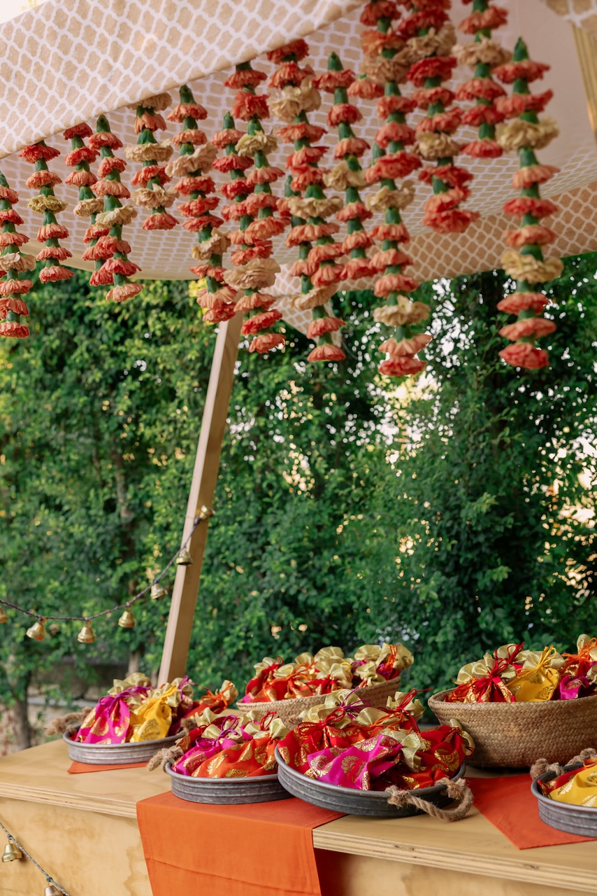 stall for bangles ritual with orange carnation garlands and colorful gifts
