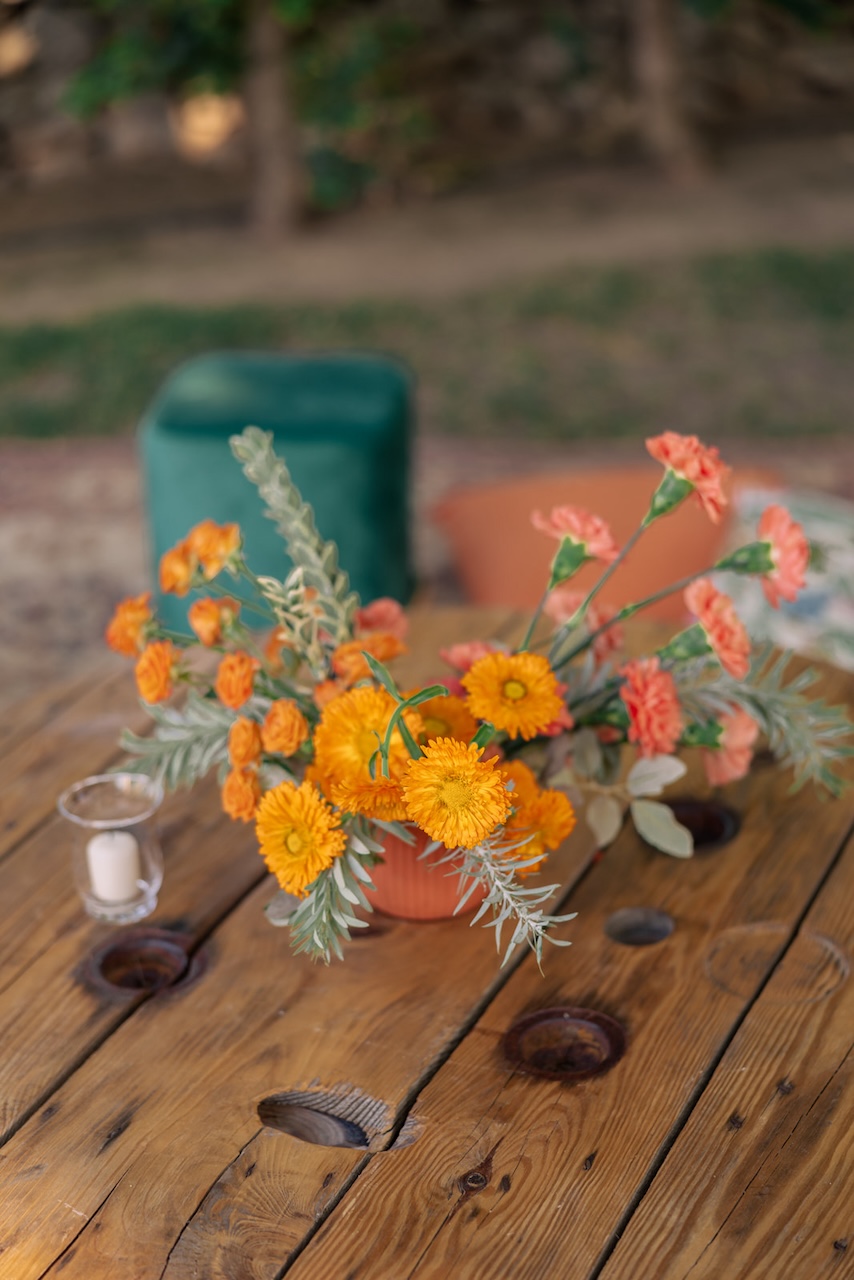 centerpiece with orange carnation at Riccardo Caffè party